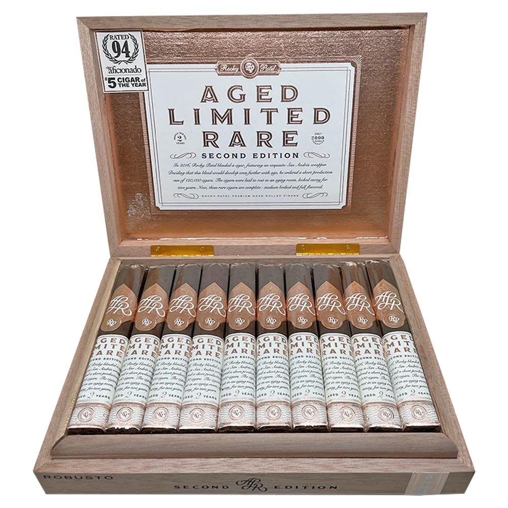 Open wooden box displaying a collection of Rocky Patel Aged Limited Rare Second Edition cigars arranged neatly, showcasing premium packaging and design.
