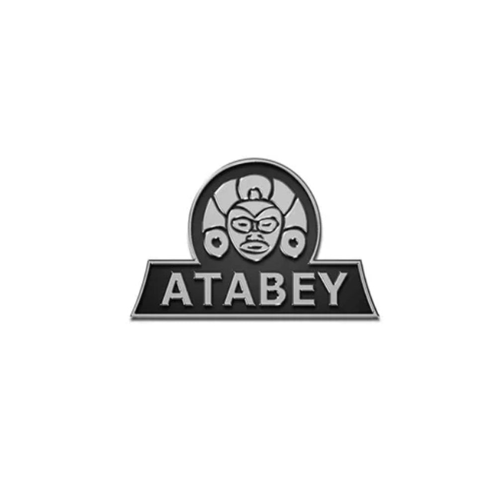 Logo design featuring the word "Atabey" with a stylized ancient face above it in monochrome.
