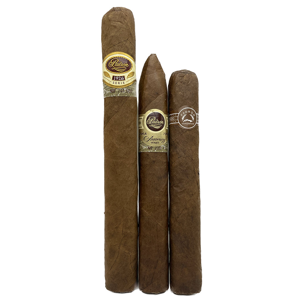 Three Padron cigars of varying sizes with labels, standing upright against a white background.