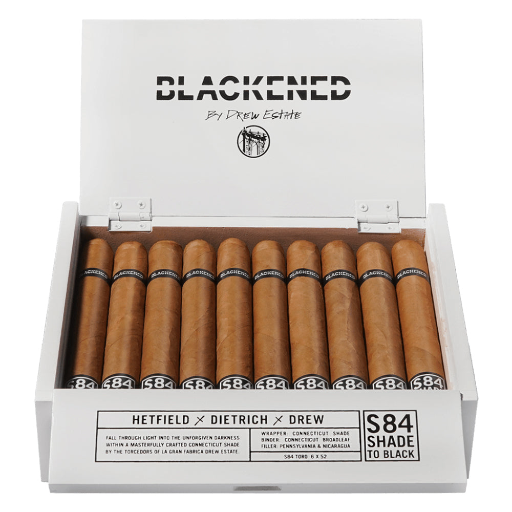 Open box of Blackened cigars by Drew Estate, featuring neatly arranged cigars with visible labels and a white box with branding and product information.