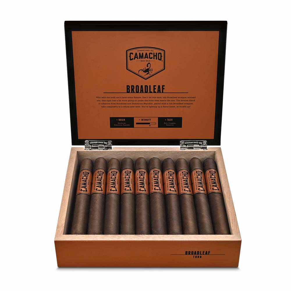 Open box of Camacho Broadleaf Toro cigars showing ten dark brown cigars neatly arranged inside with an orange and black label design.