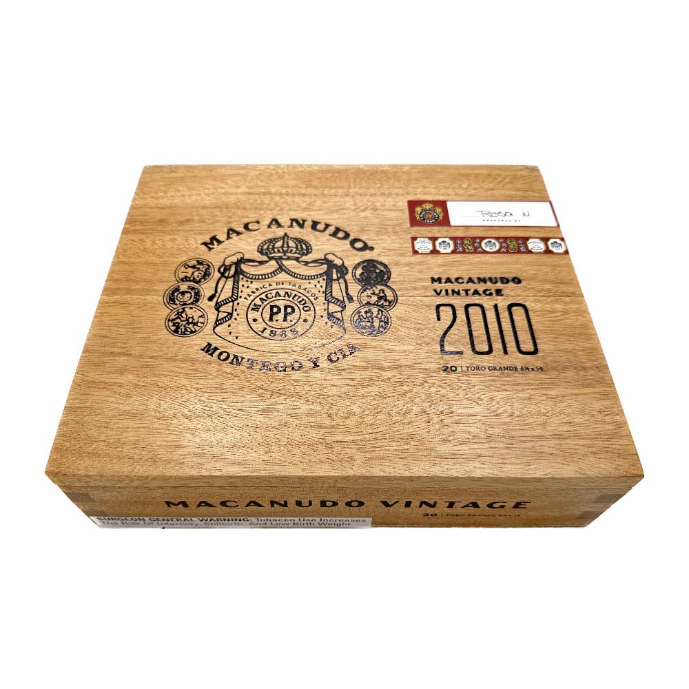 Macanudo Vintage 2010 cigar box with branded logo and design on the wooden surface.