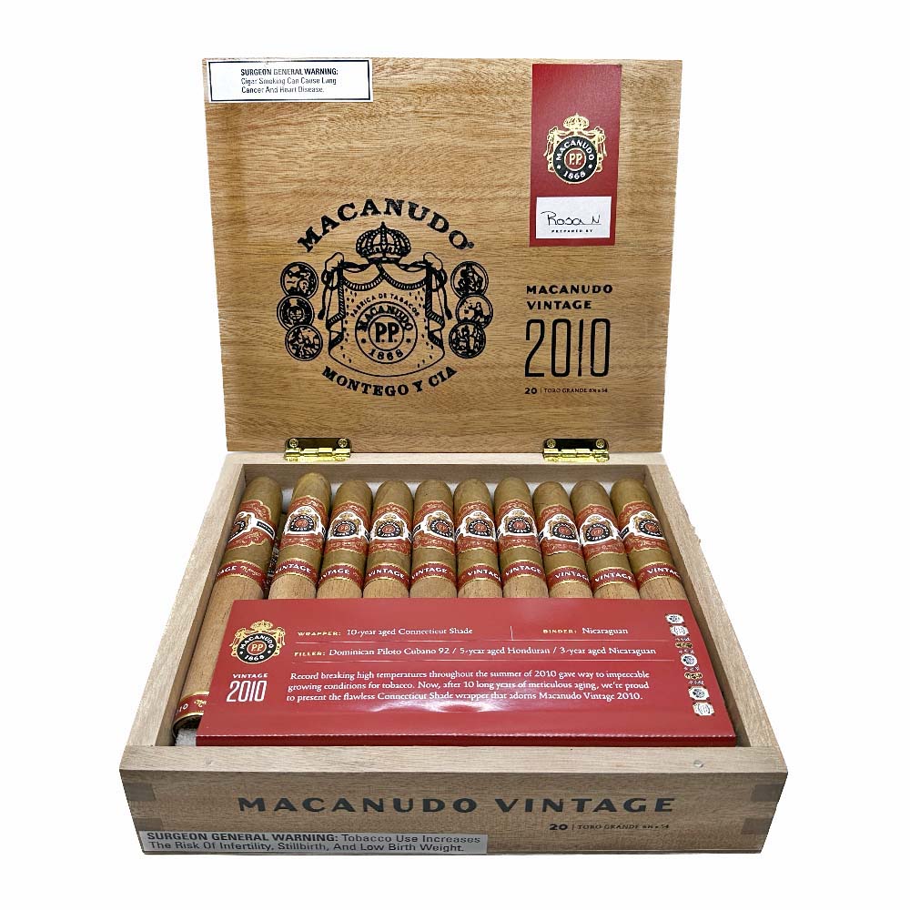 Open box of Macanudo Vintage 2010 cigars with detailed label and branding on the lid.
