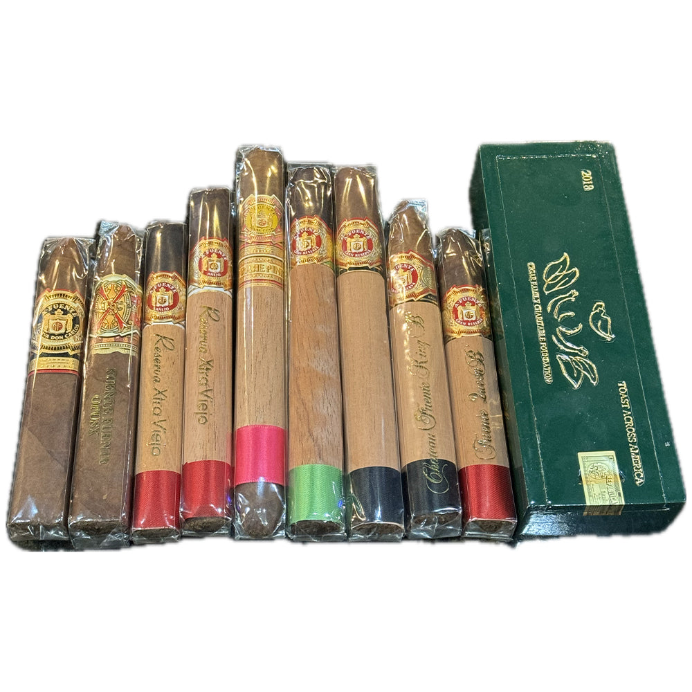 Assorted premium cigars with colorful bands in packaging next to a green box.