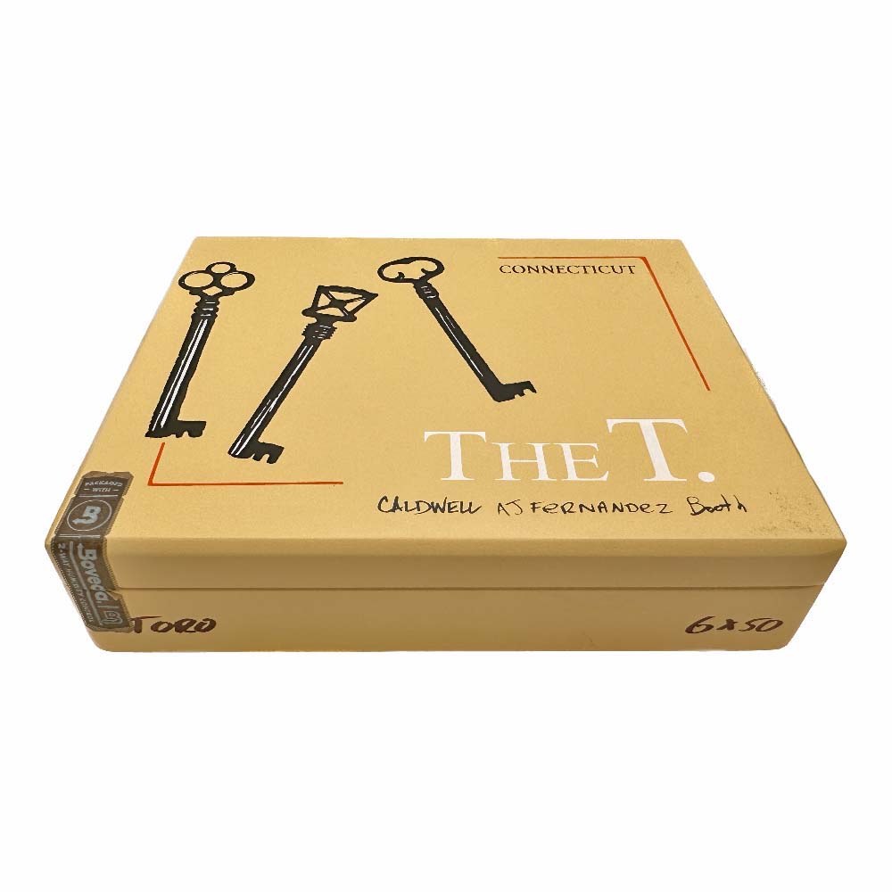 Tan cigar box labeled "The T." featuring three vintage keys and Caldwell AJ Fernandez collaboration text.