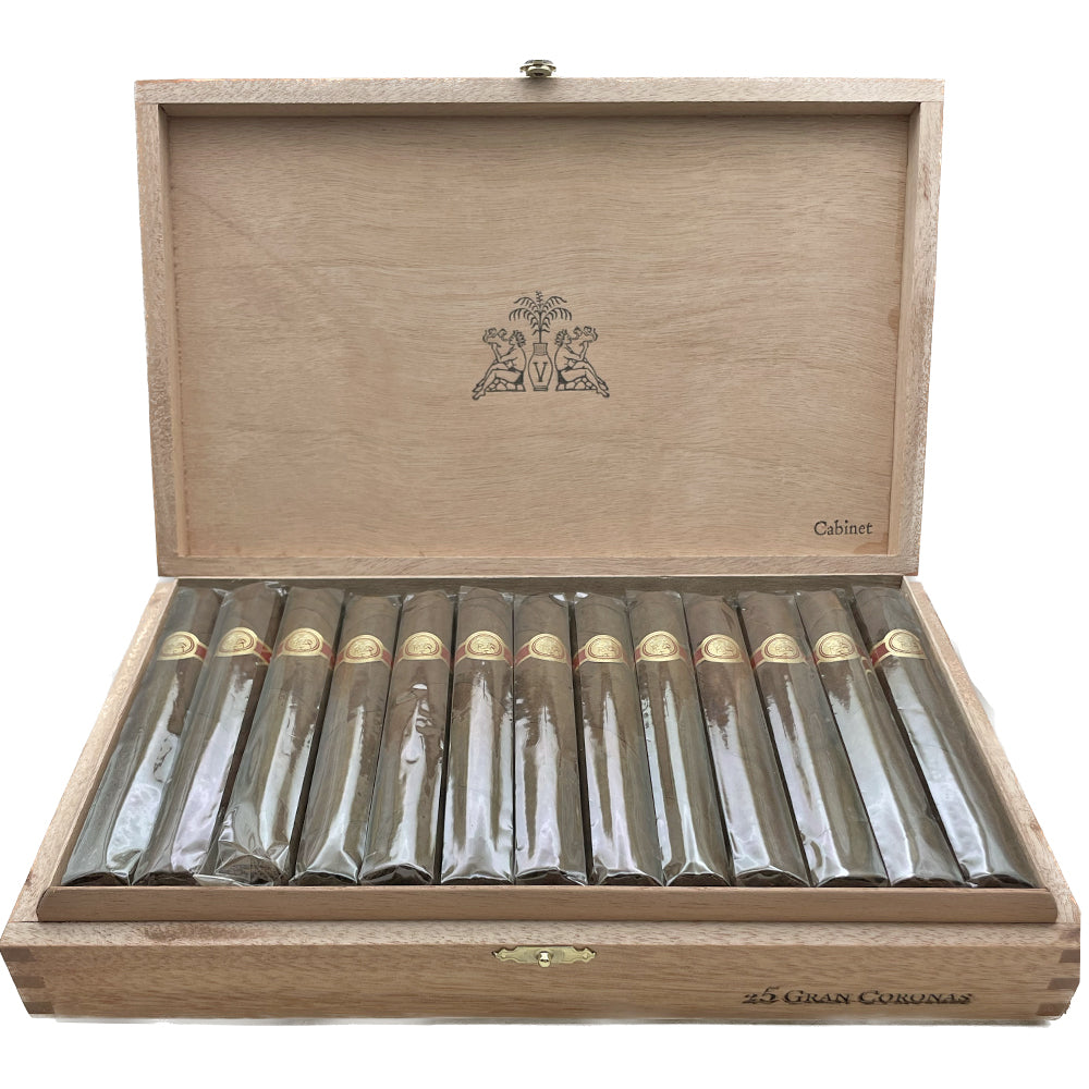 Open wooden box containing 25 premium cigars with band labels visible, arranged neatly in rows.